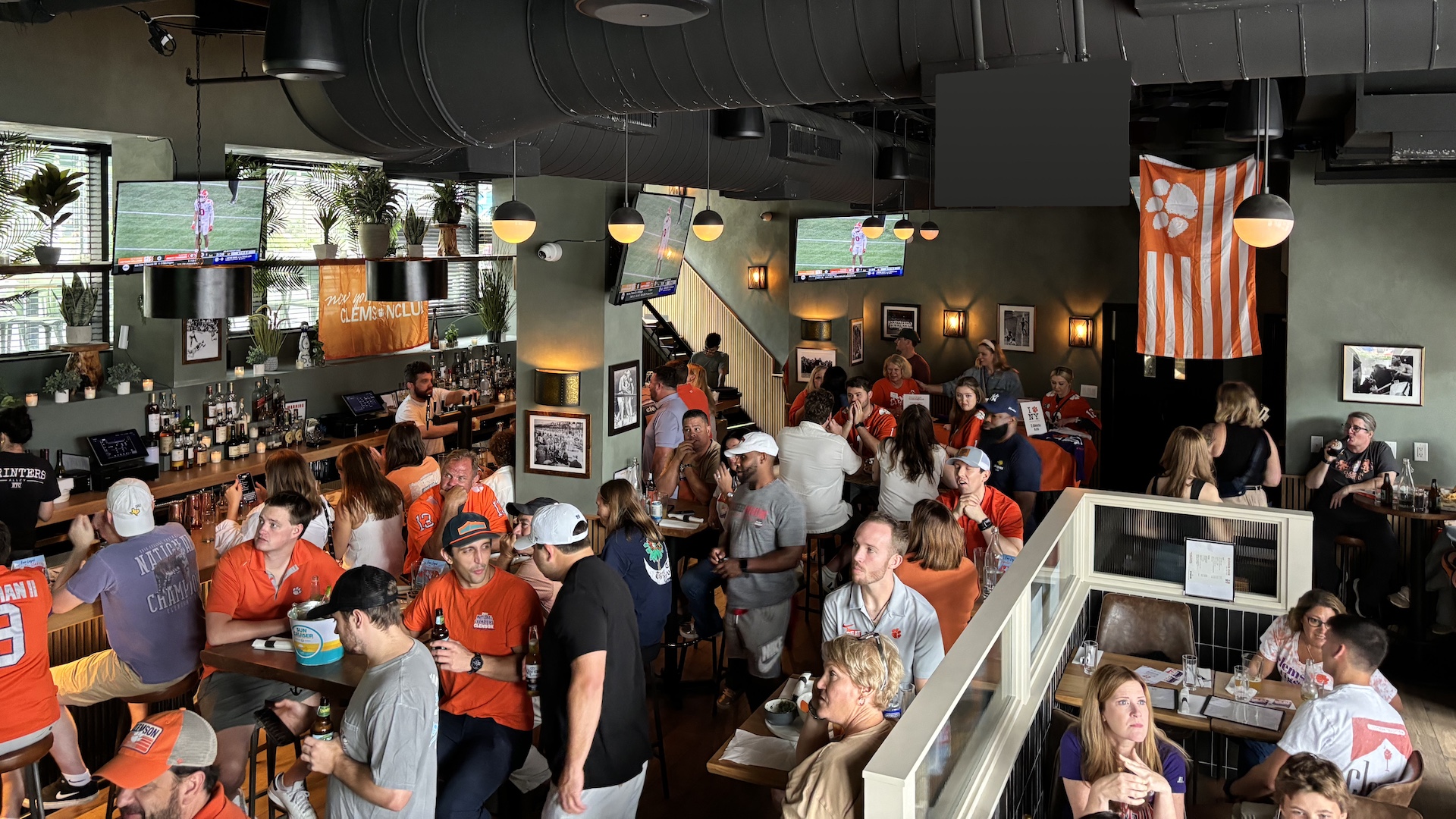 A crowded bar of Clemson fans.